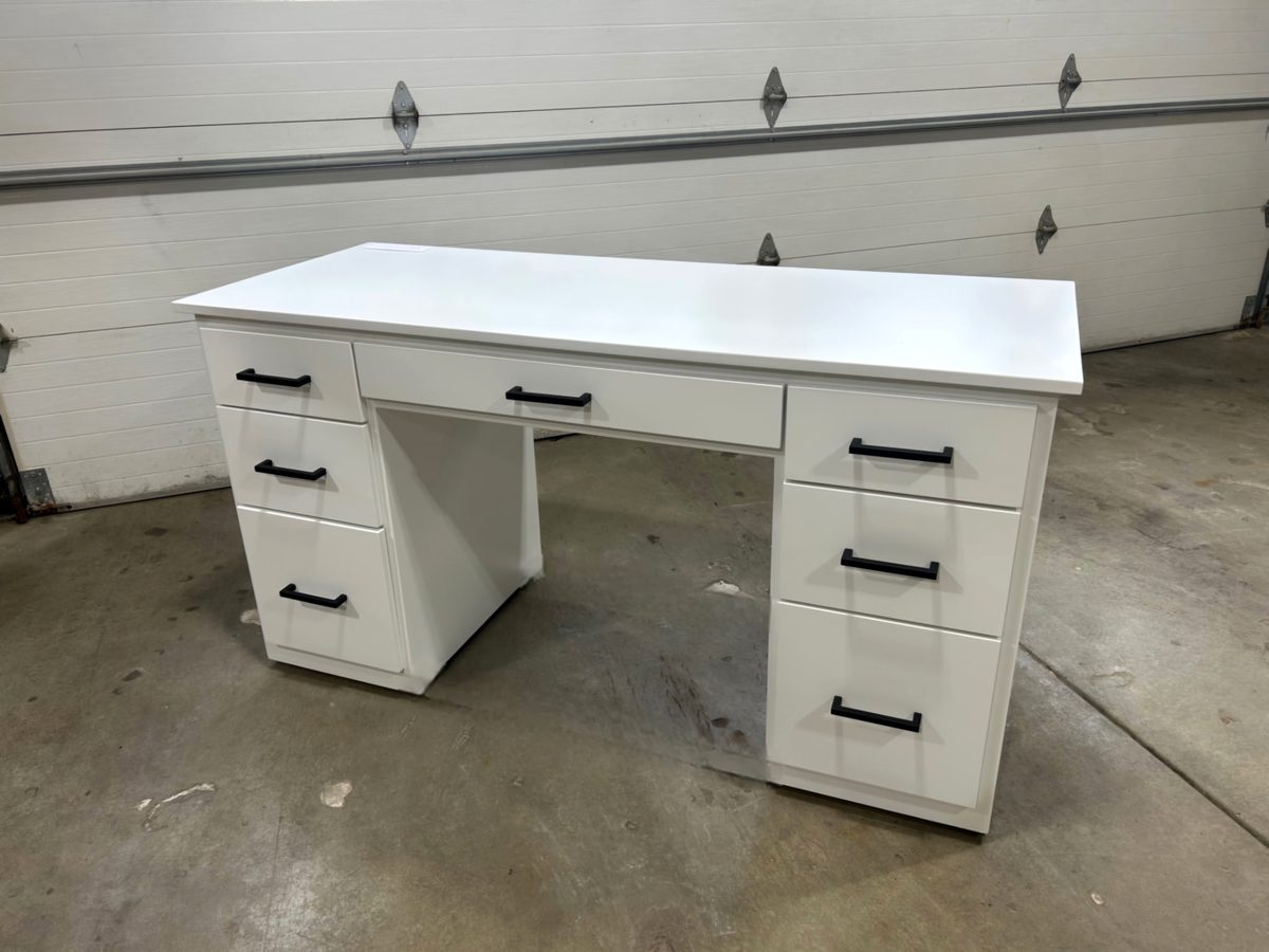 White painted desk with seven drawers and matte black pulls, photographed in the shop